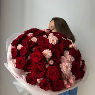 Large bouquet of red and blush roses wrapped in white paper