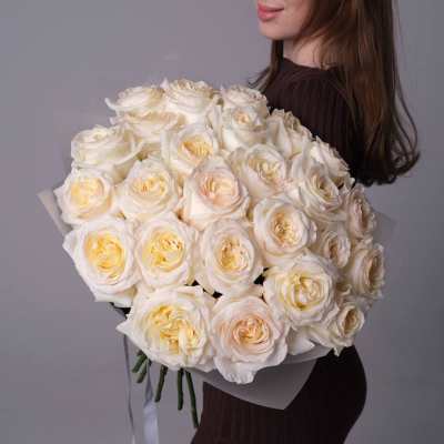 Woman holding a large bouquet of white roses
