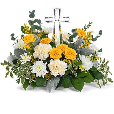 Low yellow and white floral arrangement with roses, carnations, mums and a clear crystal cross in the center