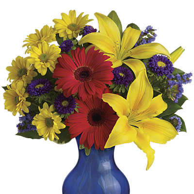 Colorful bouquet of yellow lilies, red gerbera daisies, and purple flowers in a blue vase