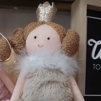 Plush princess doll with glitter crown, furry beige dress, and rope legs sitting on a shelf