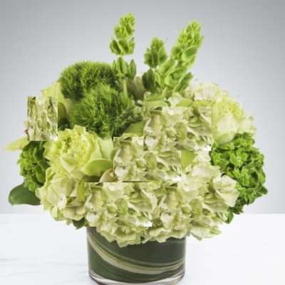 Green hydrangea arrangement in a glass vase