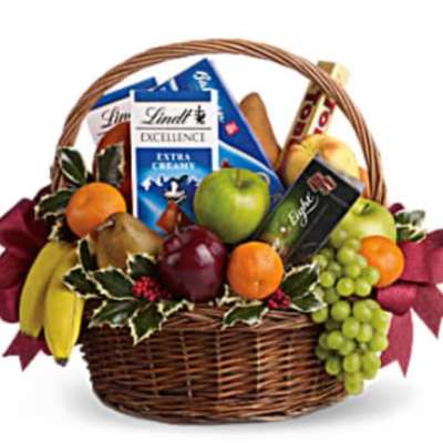 Gift basket with fruit and chocolate bars in a wicker basket