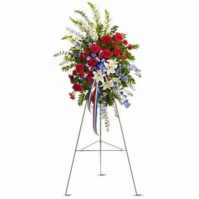 Standing floral spray with red, white, and blue flowers on an easel