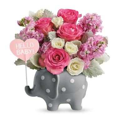 Pink and white roses and stock in a gray polka-dot elephant vase with a heart pick that reads HELLO BABY.