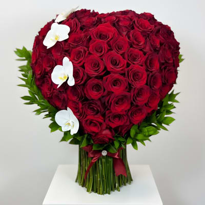 Heart-shaped bouquet of red roses with white orchids
