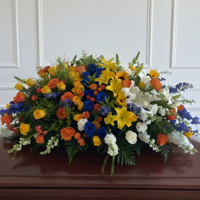 Large casket spray with multicolored roses and lilies