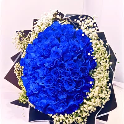 Bouquet of vivid blue roses with white baby's breath