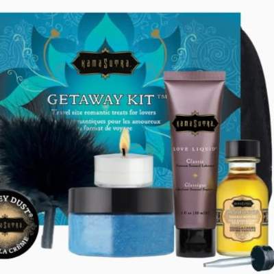 Travel gift kit with lotion, candle, scrub, oil, and a feather accessory