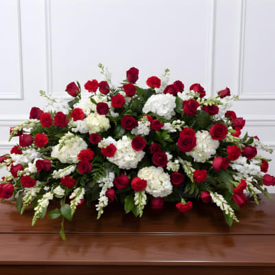 Red roses and white carnations arranged on a casket