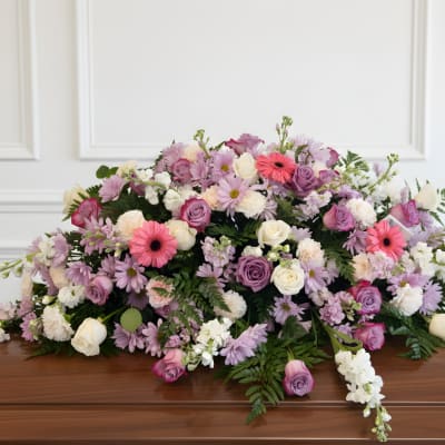 Large pastel floral casket spray with roses and daisies