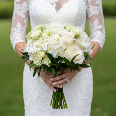 Bride holding a white rose and hydrangea bouquet