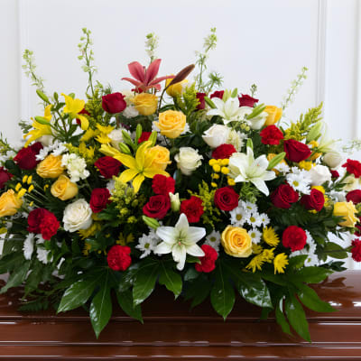 Large casket spray with red, yellow, and white flowers