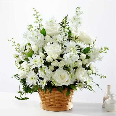 White floral arrangement in a woven basket