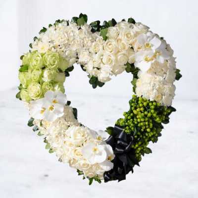 Heart-shaped floral wreath with white roses and orchids