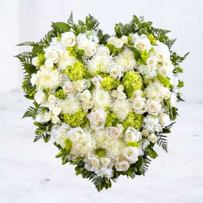 Heart-shaped floral arrangement of white roses and green hydrangeas