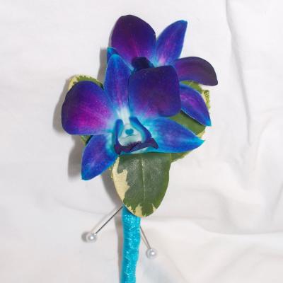 Blue and purple orchid boutonniere with a glittery turquoise stem wrap