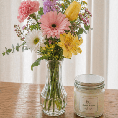 Mixed bouquet in a clear glass vase with pink, yellow, white, and purple flowers