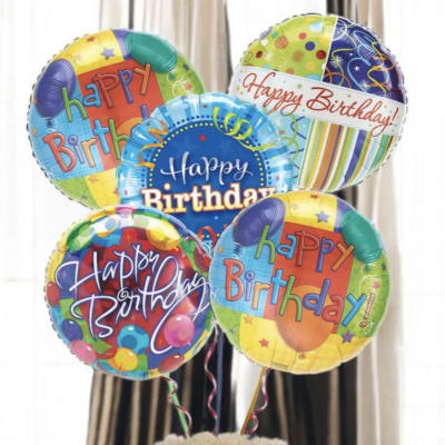 Birthday balloons above a teddy bear