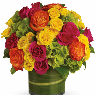Bouquet of multicolored roses in a green glass vase
