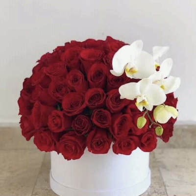 Red roses with white orchids in a white hat box