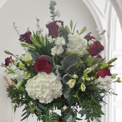 Bouquet of red roses and white hydrangeas in a glass vase