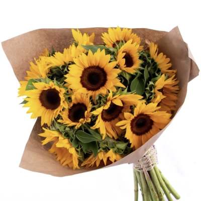 Bouquet of yellow sunflowers wrapped in brown paper