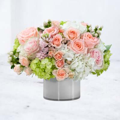 Pink and white rose arrangement in a gray vase