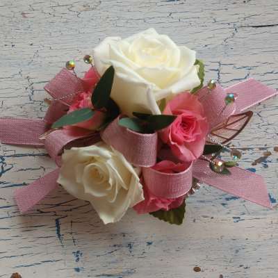 Pink and white rose corsage with ribbon accents