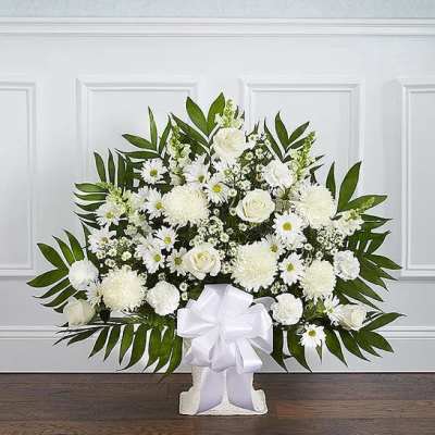 White floral standing spray with a large ribbon bow