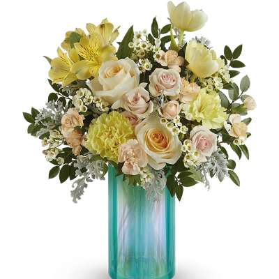 Bouquet of pale roses, yellow flowers, and carnations in a turquoise vase
