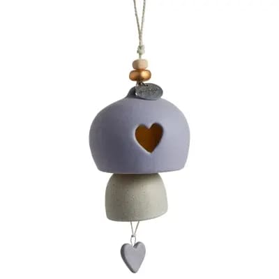Hanging ceramic ornament with a heart cutout and dangling heart charm