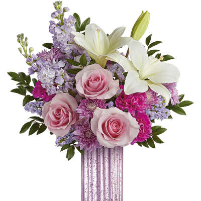 Pink roses and white lilies in a pink glass vase