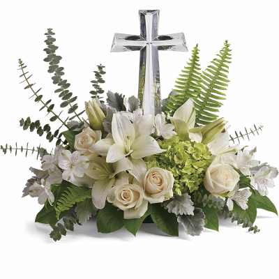 White floral arrangement with a silver cross centerpiece