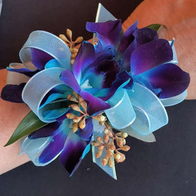 Purple orchid corsage with light blue ribbon loops