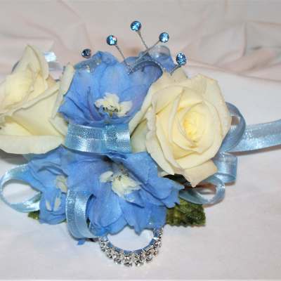 Blue and cream floral wrist corsage with ribbon and rhinestone accents