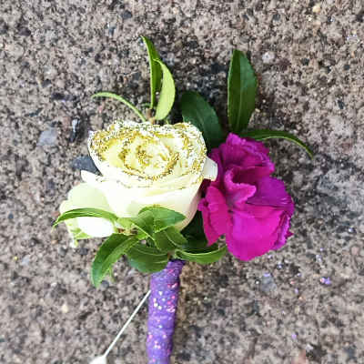 Boutonniere with white rose and magenta carnation on a purple glitter stem