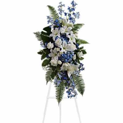 Tall white and blue floral standing spray on an easel