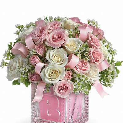 Pink and white rose arrangement in a glass block vase with ribbon