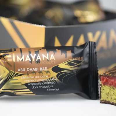 Chocolate bar wrapper with a cut piece showing layered filling