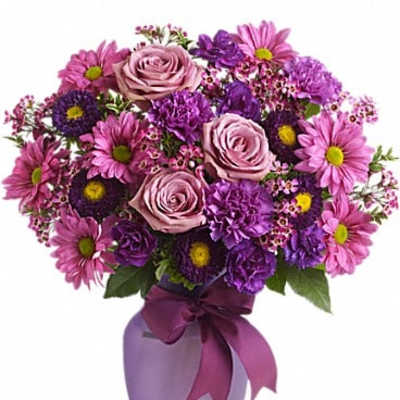 Purple and pink bouquet in a lavender vase with a ribbon