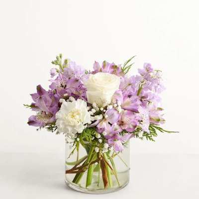 Lavender and white bouquet in a clear glass vase