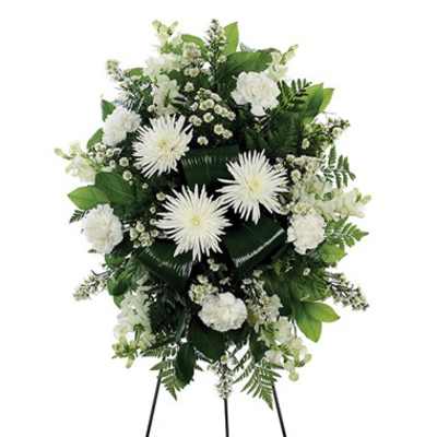White funeral spray with chrysanthemums and greenery on a stand