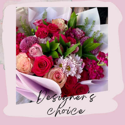 Bouquet of pink and red roses with purple mums in white wrap