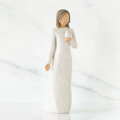 Figurine of a girl in a white dress holding a small white bird