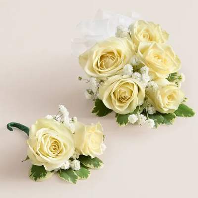 Cream rose corsage and boutonniere with white filler flowers