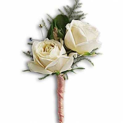 Two white rose boutonnieres with pink ribbon-wrapped stems