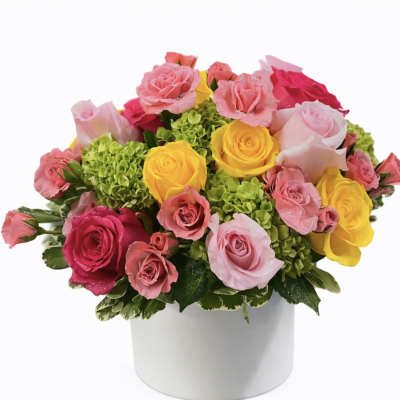 Mixed roses in pink, yellow, and red arranged in a white box