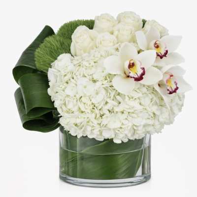 White floral arrangement with orchids and roses in a glass vase