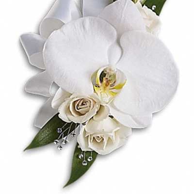 White orchid corsage with cream roses and green leaves